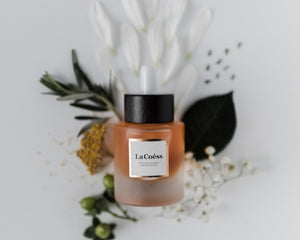 La Coéss Revitalisé Organic Face Oil surrounding with nature flower and plants botanicals Holistic skin care